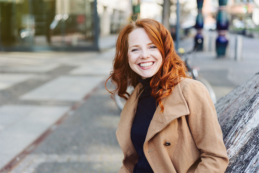 happy red haired girls walking down the street