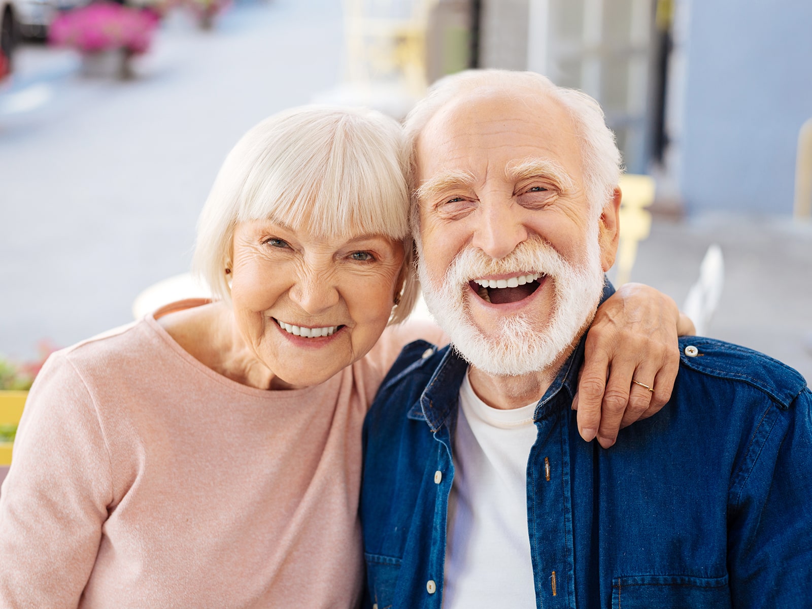 Elderly couple smiling on their back patio